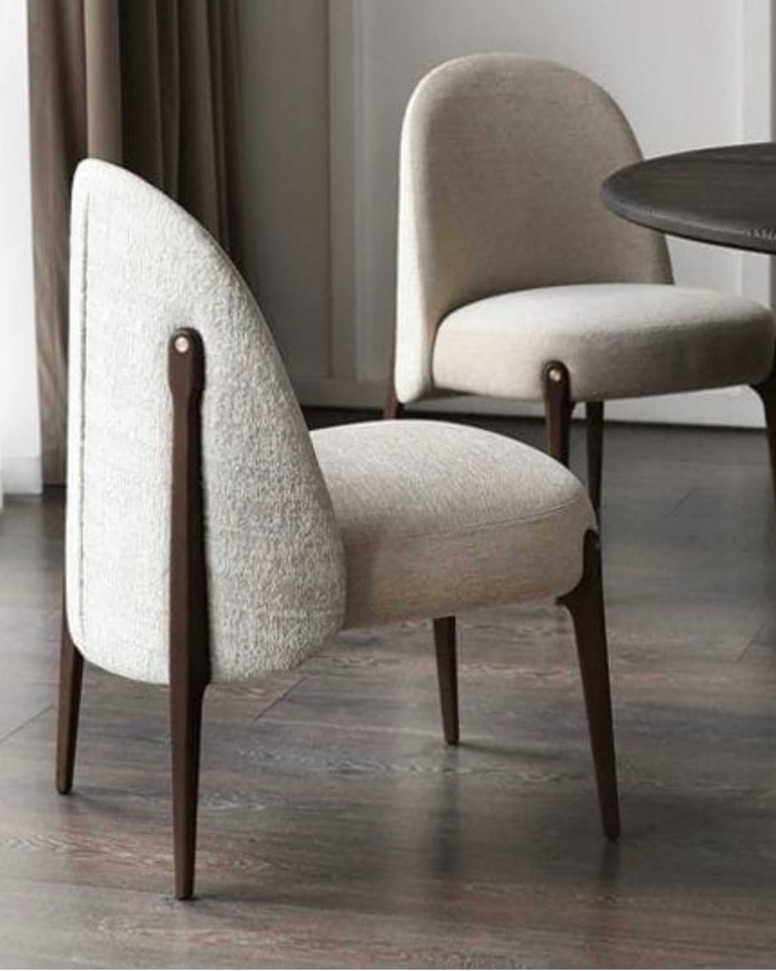 NORA premium upholstered dining armchair with tall curved cream back, padded seat and dark walnut wooden frame.